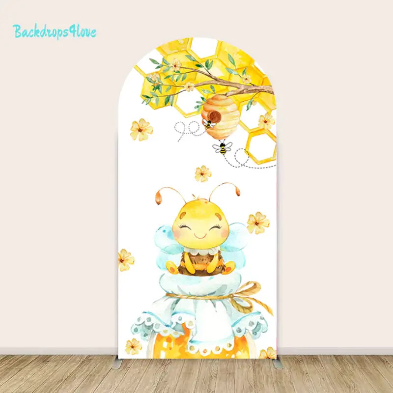 Arched backdrop featuring a happy bee seated on a honey jar surrounded by sunflowers, honeycomb, and floral accents.