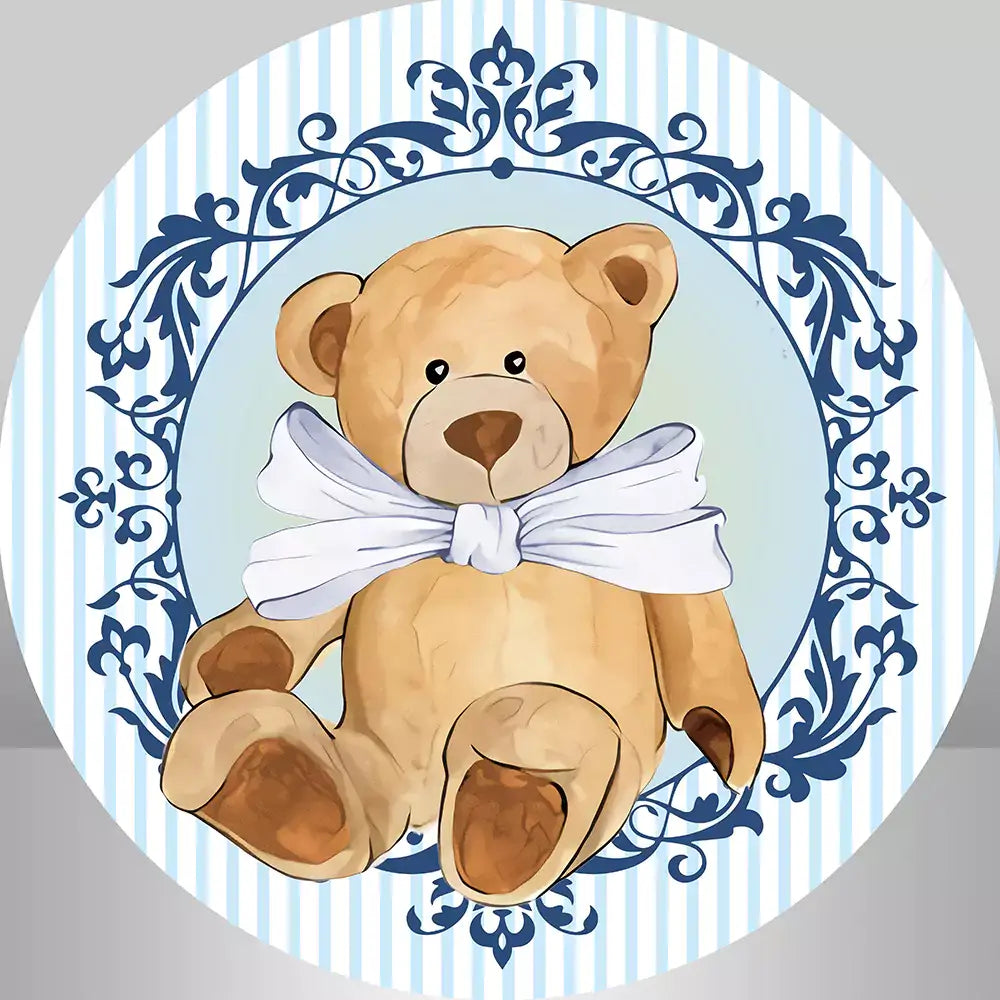 round backdrop fatures blue and white stripes and a teddy bear with a white bow tie sits in a blue vintage frame