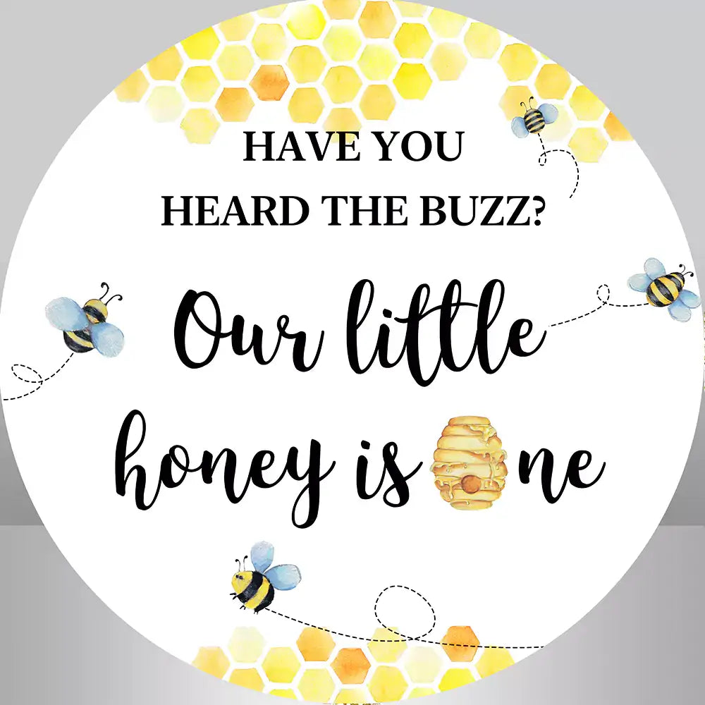 a bee themed 1st round backdrop features our little honey is one text