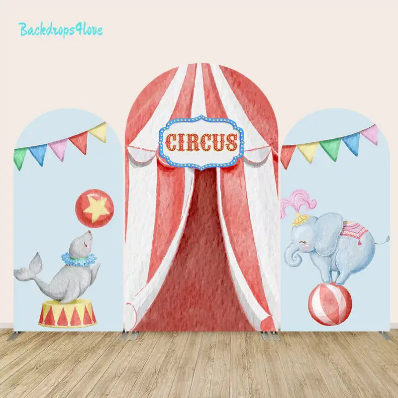 Circus-themed arch backdrop featuring a circus tent, a seal balancing a ball, and an elephant on a ball