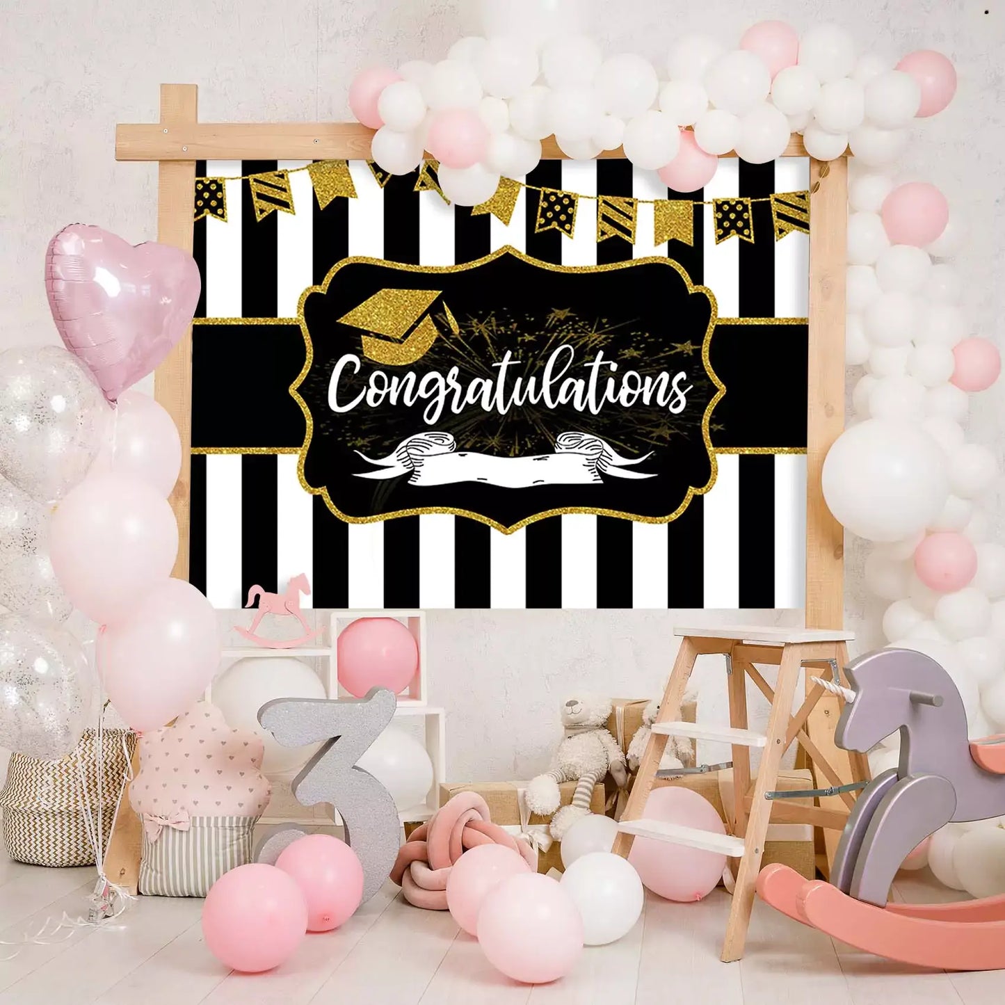 Elegant black and gold striped graduation backdrop with festive decorations and "Congratulations"