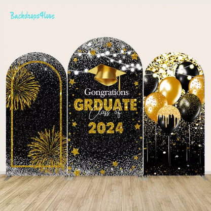 Class of 2024 graduation arch backdrop set featuring black and gold designs with fireworks, balloons, and a graduation cap