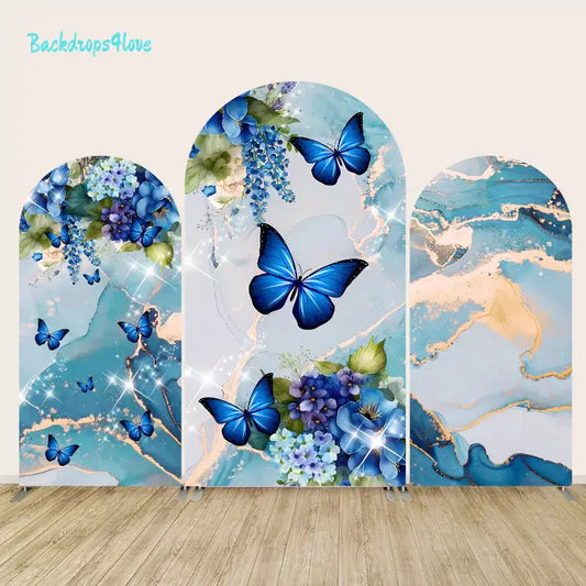 Blue butterfly and floral-themed arch backdrop set with three panels featuring vibrant blue hydrangeas, butterflies, and elegant marble textures with gold accents.