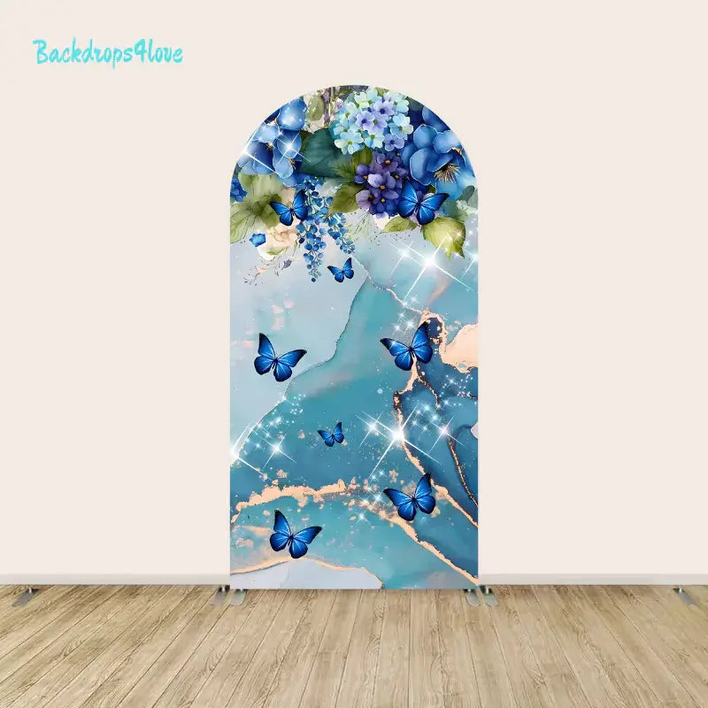 Left arch panel of the blue butterfly backdrop set featuring butterflies, blue hydrangeas, and floral accents on a marbled background.