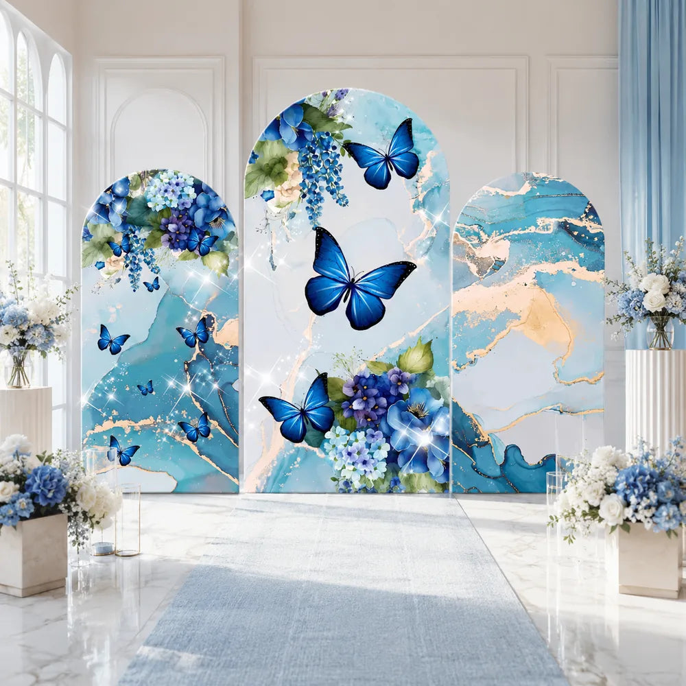 Three-piece blue butterfly arch backdrop covers set with blue floral arrangements, aqua marble patterns and elegant gold veining for party and event decorations.