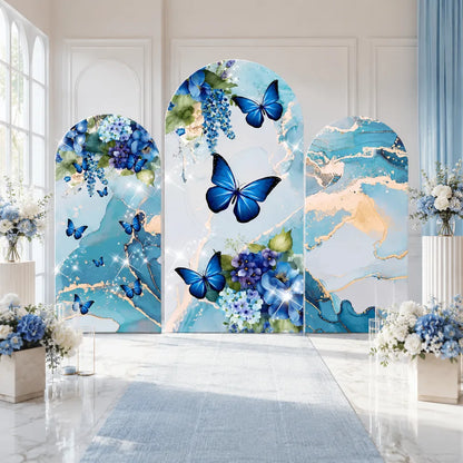 Three-piece blue butterfly arch backdrop covers set with blue floral arrangements, aqua marble patterns and elegant gold veining for party and event decorations.
