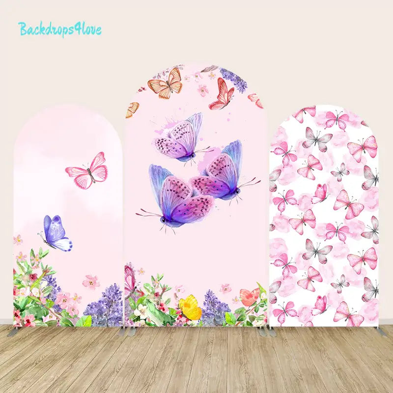 Butterfly-themed arch backdrop featuring pink and purple butterflies with floral accents