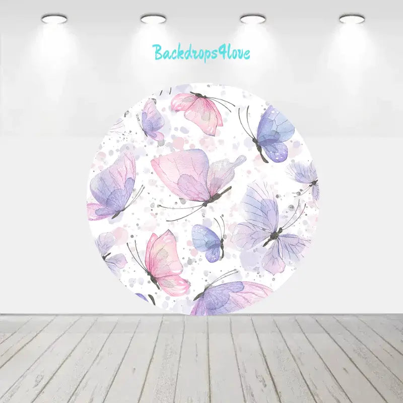 Butterfly-themed party backdrop with a whimsical design of colorful butterflies and matching pastel pink and blue cylinder covers for event decor.