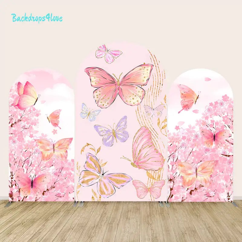 A 3-panel pink butterfly backdrop set featuring large golden butterflies on the center panel and cherry blossom trees with fluttering butterflies on the left and right panels, perfect for garden-themed events and photo decor.