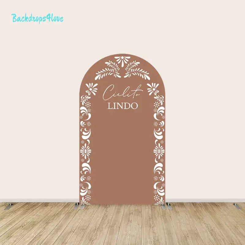 Center arch panel of the Cielito Lindo backdrop set with floral accents, terracotta background, and the text "Cielito Lindo."