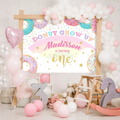 Colorful Donut Grow Up first birthday backdrop with personalized name and donut designs, perfect for kids' parties