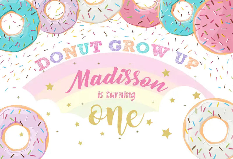 Personalized donut-themed first birthday party backdrop with Donut Grow Up design and colorful decorations