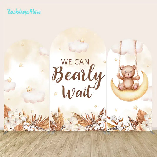 Cute teddy bear on moon swing arch backdrop with 'We Can Bearly Wait' text for baby showers and gender reveal parties