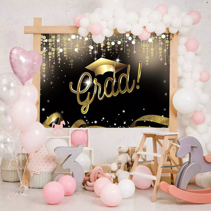 Elegant black and gold graduation party backdrop with a graduation cap and festive decorations