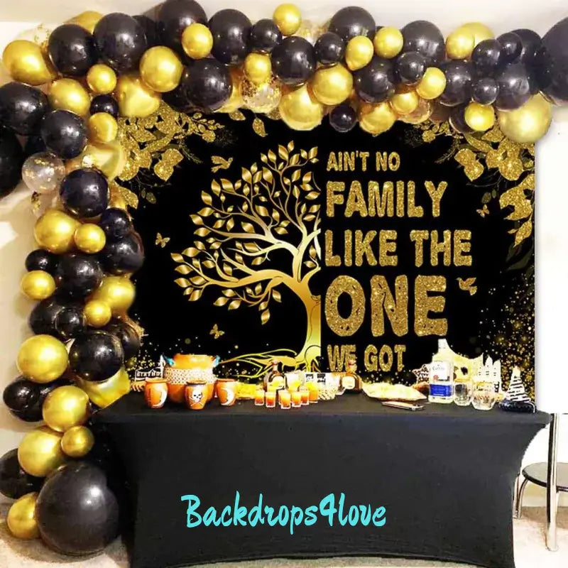 Family celebration backdrop with black and gold design, featuring a glittering tree and inspiring family-themed message.