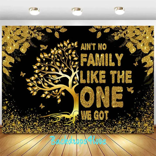 Gold and black family-themed backdrop with glittering tree design and the text 'Ain’t No Family Like the One We Got.