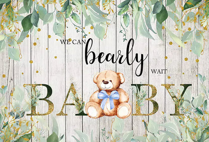 banner that features a teddy bear with a blue bow on a wooden background and text that says "We Can Bearly Wait! Baby"