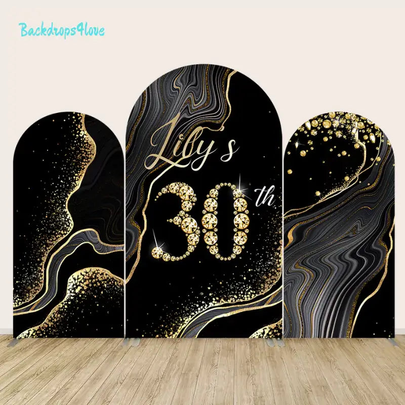 Arch backdrop set with luxurious black and gold designs and glittering elements for a 30th birthday party