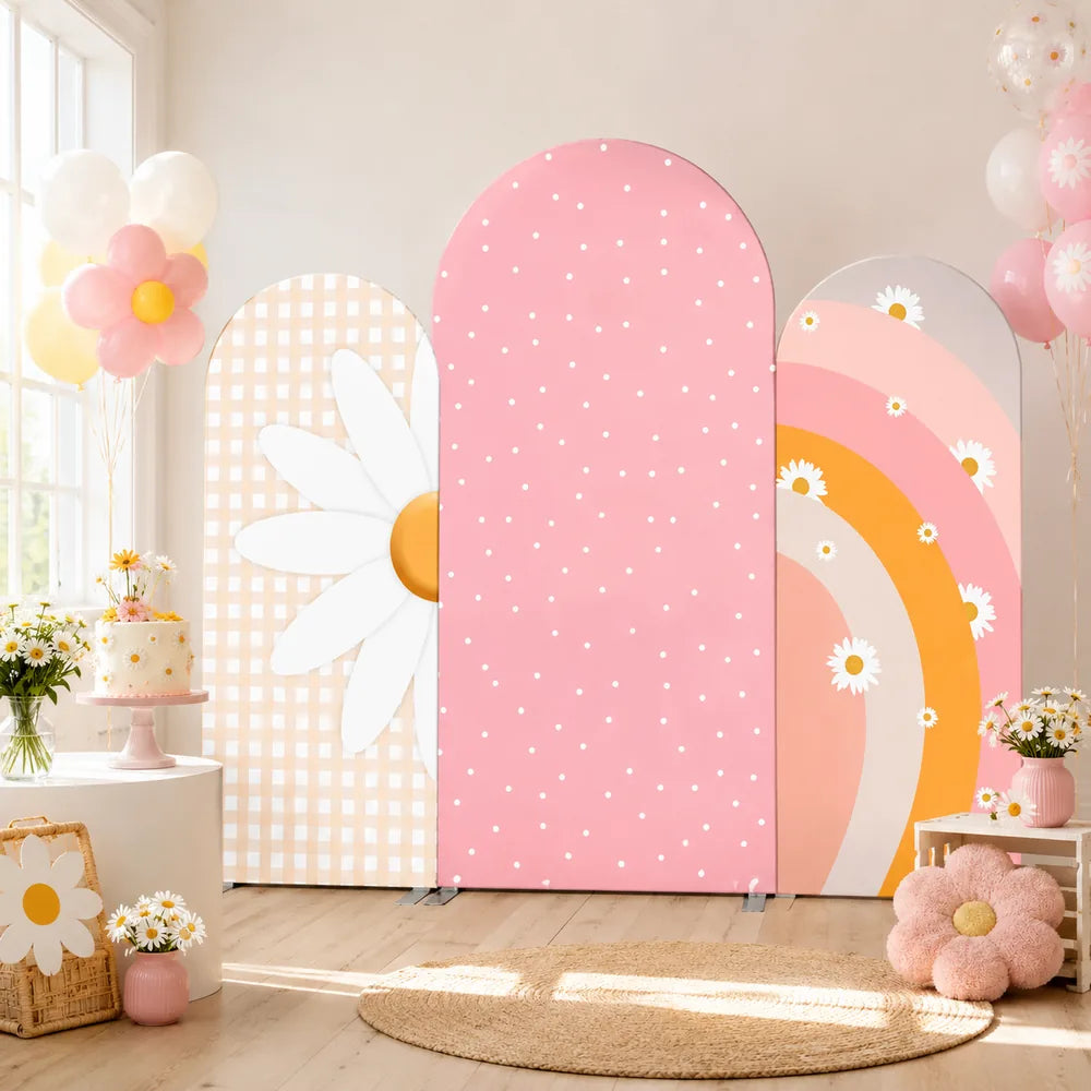 Three-piece pastel daisy arch backdrop covers set with beige gingham, pink polka dots and a peach rainbow floral design for birthday party decorations.