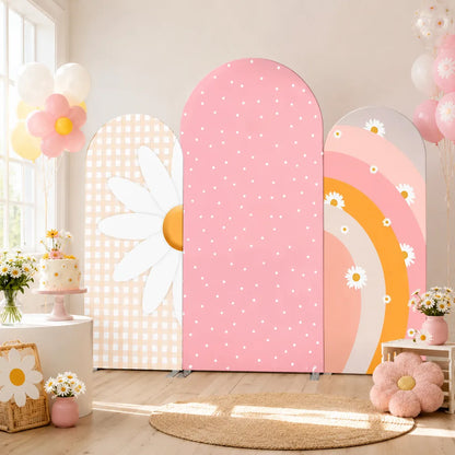 Three-piece pastel daisy arch backdrop covers set with beige gingham, pink polka dots and a peach rainbow floral design for birthday party decorations.