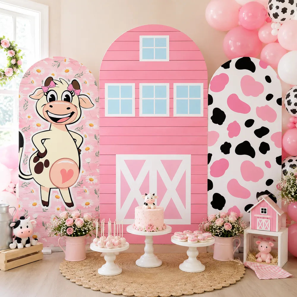 Three-piece pink cow farm arch backdrop covers set with a cartoon cow, pink barn design, daisy flowers and black and pink cow print for a girls birthday party.