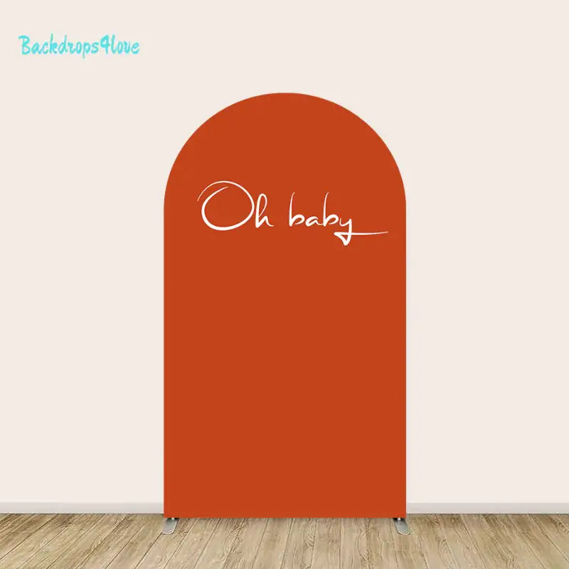 Center arch in solid rust orange with elegant handwritten ‘Oh baby’ script.