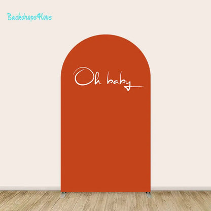 Center arch in solid rust orange with elegant handwritten ‘Oh baby’ script.