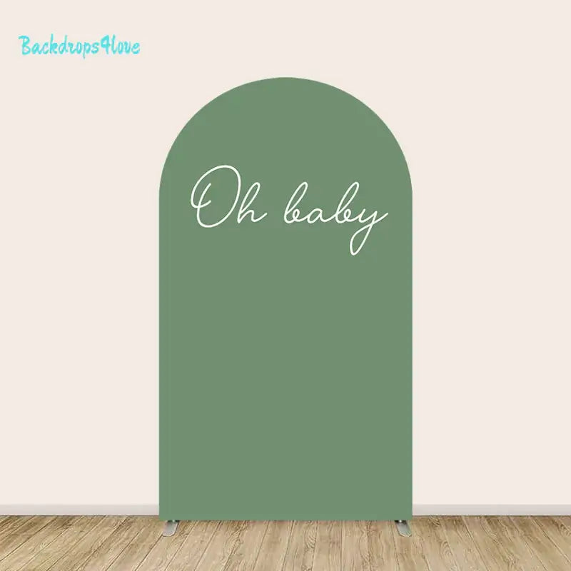 Center arch with solid sage green background and elegant handwritten ‘Oh baby’ script.