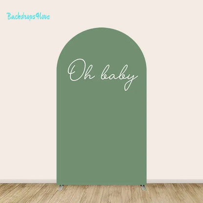 Center arch with solid sage green background and elegant handwritten ‘Oh baby’ script.