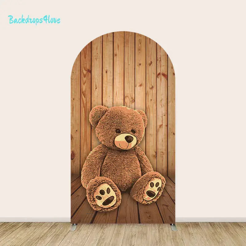 Middle arch displaying a big teddy bear sitting on a wooden floor backdrop