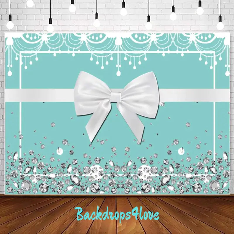 A glamorous Tiffany blue backdrop with a large white satin bow in the center, adorned with sparkling gemstones and pearls at the bottom, perfect for elegant events like weddings, bridal showers, or birthdays.