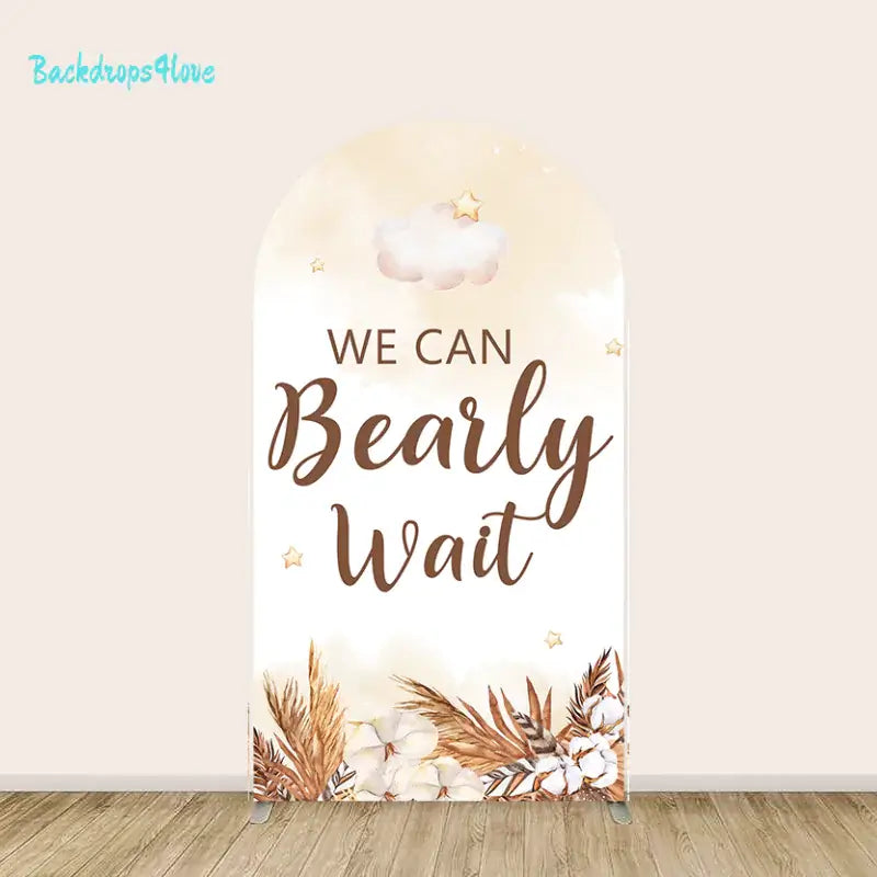 Center arch backdrop with 'We Can Bearly Wait' text, clouds, stars, and floral accents for baby shower